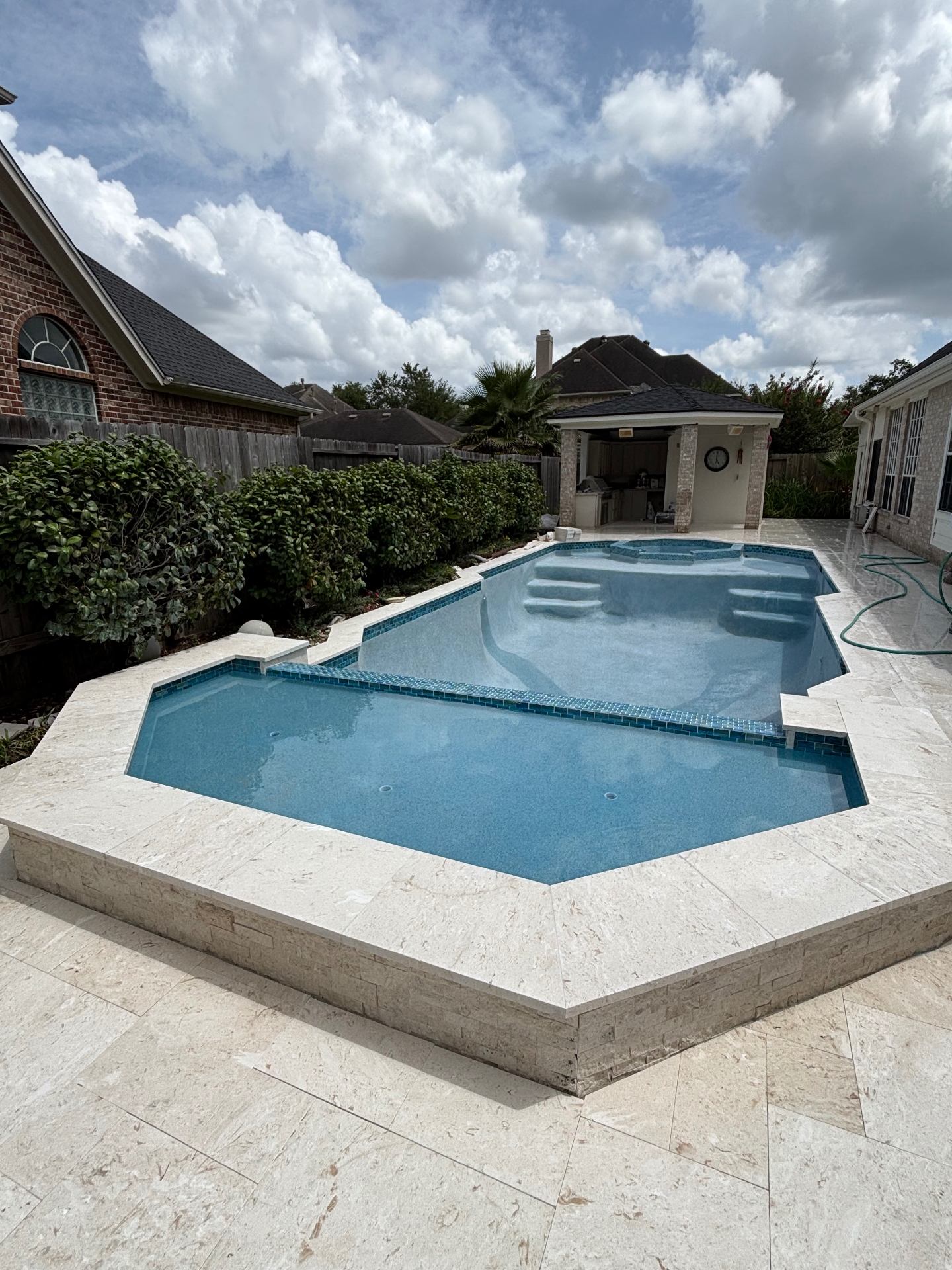 Custom Spa & Travertine Deck · Houston